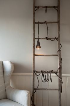 an old wooden ladder with lights hanging from it