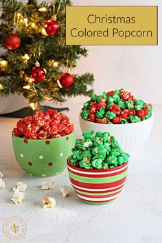 two bowls filled with christmas colored popcorn next to a small christmas tree in the background