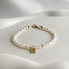 "Our simple, minimalist 14k Gold Filled Pearl Initial Bracelet is a perfect everyday look. Whether you are going to work, date night or a girls night out, this dainty gemstone bracelet is an ideal staple piece for your jewellery collection.  SIZING  Please measure your wrist and choose the size according to the style of fit you prefer. If you don't know your size or if it is a gift for a loved one, you can choose to add an extender and it will be made 6\" with a 2\" extender.  If you do not see your size please just message me. I am happy to help!   MATERIALS & COMPONENTS * Made with natural baroque seed keshi pearls, and your choice of either 925 Sterling Silver or 14k Gold Filled clasp  * Choose between 18k Gold Plated Stainless Steel or Silver Plated Stainless Steel Initial Letter * Tar Elegant Personalized Pearl Bracelet For Everyday, Elegant Everyday Personalized Pearl Bracelet, Minimalist Handmade Pearl Bracelet For Everyday, Handmade Minimalist Pearl Bracelet For Everyday, Pearl Letters, Bracelet Initial, Pearl Accessories, Simple Pearl, Bracelet Simple