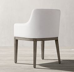 a white chair sitting on top of a wooden floor