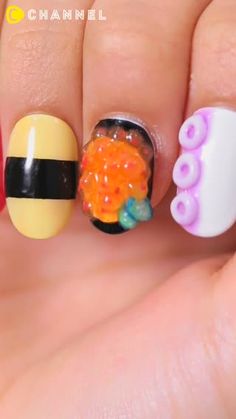 a hand with three different nail designs on it, one has a bee and the other is