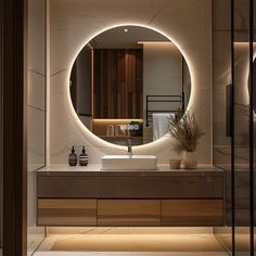 a bathroom with a round mirror on the wall above it and a sink in front of it