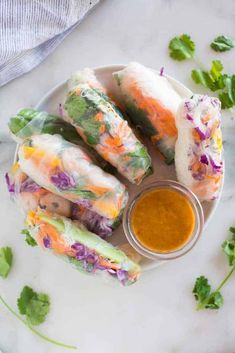 vegetable spring rolls on a plate with dipping sauce