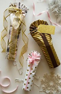 three different types of candy wrapped in gold and pink ribbons with bows on them, along with other decorative items