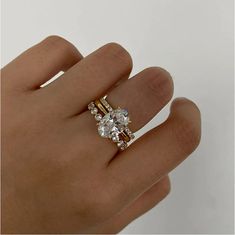 a person's hand with a ring on top of it and a diamond in the middle