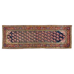 an antique persian rug with blue, red and gold colors on the border is shown