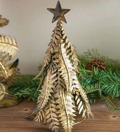 a gold christmas tree on a wooden table