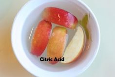 an apple sliced into pieces in a bowl with the words cttric acid on it