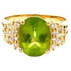 Item Specifications: Style: Statement ring Metal: 18k Yellow Gold Ring Weight: 4.90 grams Ring Size: 7 Ring Height: 10.86 mm Gemstone Specifications: Gemstone: Peridot Topaz Measurements: 10.82 mm x 8.84 mm x 5.56 Topaz Carat Weight: ~3.36 Carats Color: Lime Green Shape: Oval Transparency: Transparent Diamond Count: 14 diamonds Diamond Weight: 0.15 carats Diamond Color: H Diamond Clarity: SI2 Condition: Preowned, Excellent Stamped: "18K" "750" Please see all photos for details, feel free to ask Peridot Ring, 18k Yellow Gold Ring, Ring Metal, Yellow Gold Ring, Style Statement, Ring Size 7, Diamond Clarity, Yellow Gold Rings, Metal Rings