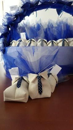 blue and white baskets with bows on top of a wooden table next to each other