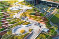 an aerial view of a building with many plants growing on the roof and walkways