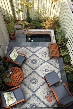 an overhead view of a small patio with chairs and potted plants in the corner