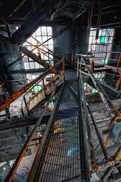 an abandoned building with metal railings and windows