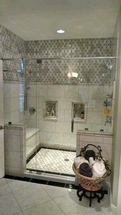 a bathroom with a walk in shower next to a bathtub and toiletries on a stand