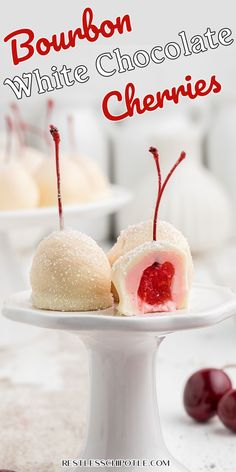 two white chocolate cherries on a plate with the words bourbon white chocolate cherries