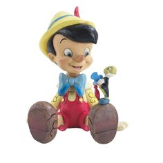 a figurine of a boy riding a toy car