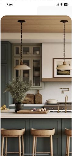 an image of a kitchen setting with bar stools and island in the middle,