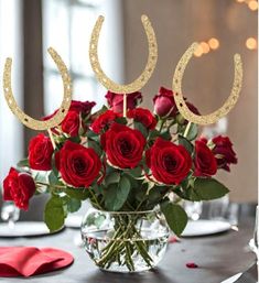 a vase filled with red roses on top of a table