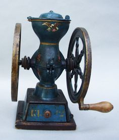 an old fashioned spinning machine with wheels on it's sides and wooden spokes