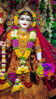 an idol is displayed in front of flowers