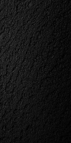 a black textured wall is shown in this image