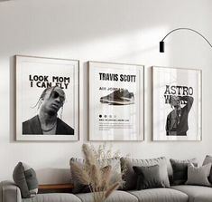 a living room filled with furniture and posters on the wall above it's couch