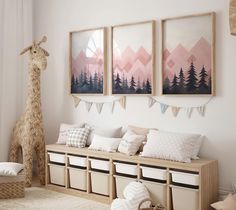 a room filled with lots of furniture and pictures on the wall next to a stuffed giraffe