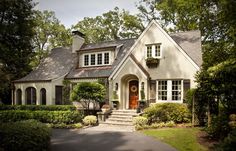 a white house surrounded by trees and bushes