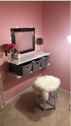 a room with pink walls and white fur rugs on the floor next to a mirror