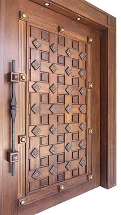 an ornate wooden door with metal handles