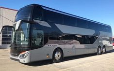 a tour bus parked in front of a building