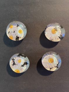 three small plates with flowers painted on them