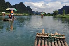 some people are out in the water on rafts with an umbrella over their heads