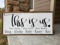 this is us sign sitting on the side of a house