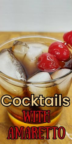 cocktails with amarettoa and cherries in a glass on a wooden table