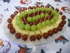 grapes and cheese are arranged on skewers with toothpicks in the middle