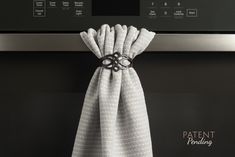 a kitchen towel hanging on an oven door