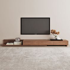 a flat screen tv sitting on top of a wooden entertainment center in a living room