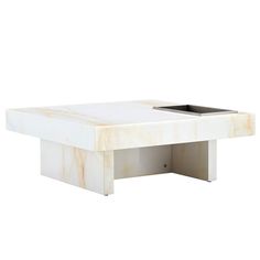 a white marble coffee table with an open drawer