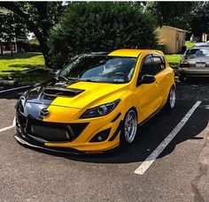 a yellow sports car parked in a parking lot