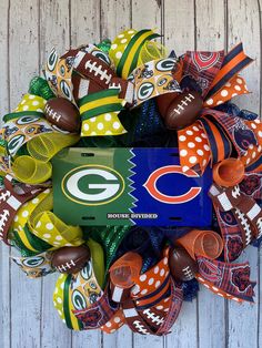 the green bay packers football wreath is decorated with polka dot bows and an nfl tag