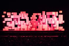 a large screen with squares on it in front of an audience at a concert or show