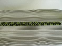 a close up of a bed with green and black designs on it