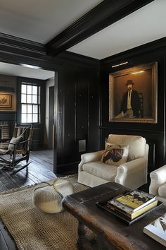 a living room with black walls and white furniture