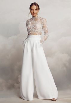 Cut from luxurious stretch crêpe, the Alexis trousers feature gorgeously flattering seam lines and fashion-forward flared legs. These trousers are perfect for those wanting an alternative to a traditional wedding dress look. These beautifully structured, high-waisted trousers feature front box pleats and back darts, wh Bridal Crop Top And Pants, Wedding Trousers Brides, Alternative Bridal Outfit, Practice Tattoos, Wedding Pantsuit, Wedding Pants, Catherine Deane, Traditional Wedding Dress, Wedding Jumpsuit