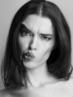 a woman with makeup on her face is making a weird face while posing for the camera