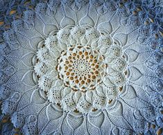 a crocheted doily is shown on a table