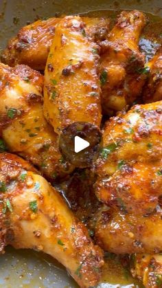 some chicken wings are cooking in a pan