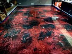 the floor is covered in red and black marbled material, which looks like corals