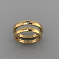 two gold wedding rings with hearts on them